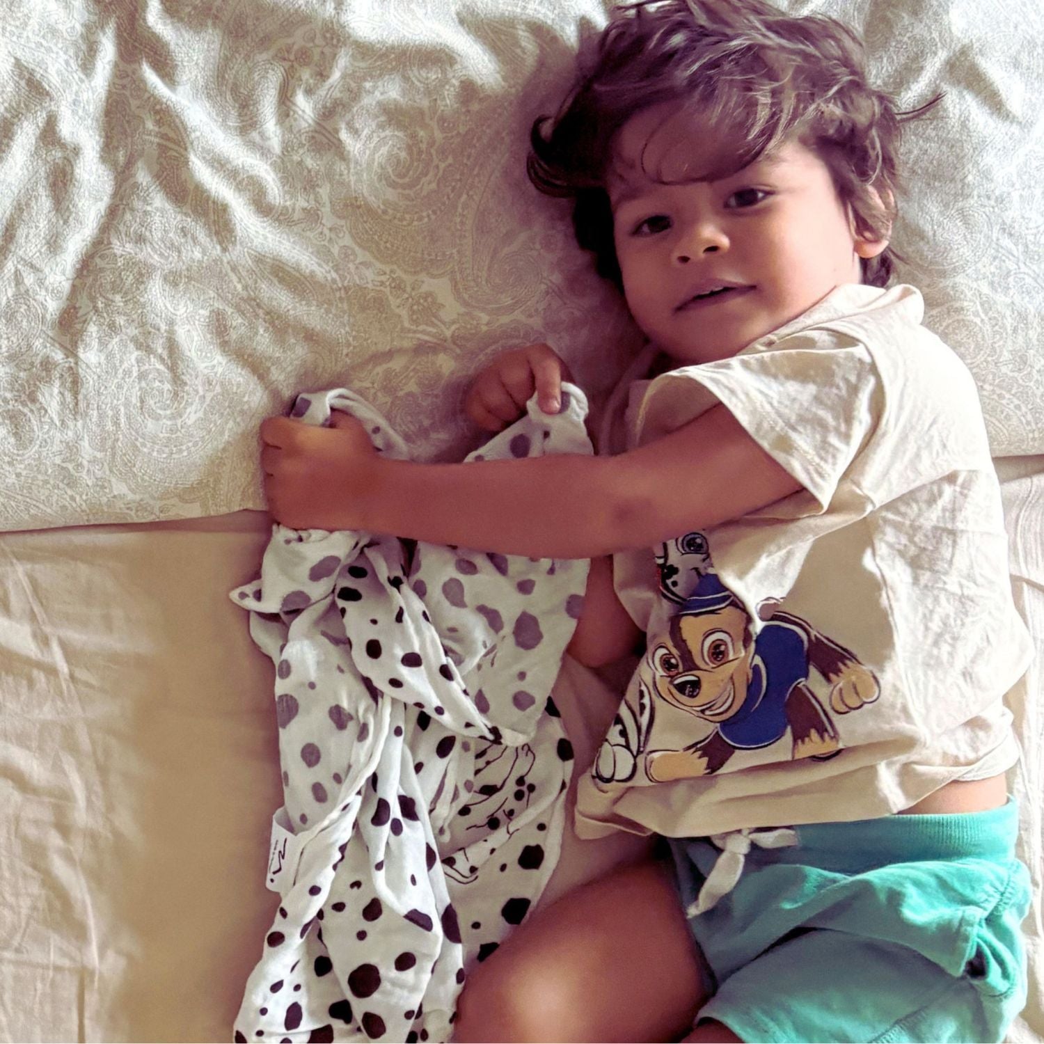 A child resting with the Small Square muslin, showing comfort and softness during quiet moments.
